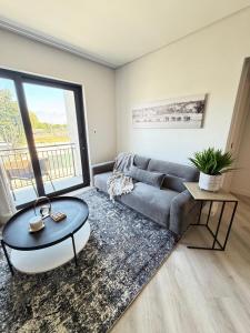 a living room with a couch and a table at Platform 123 - 2 On Tabak with onsite Parking in Paarl