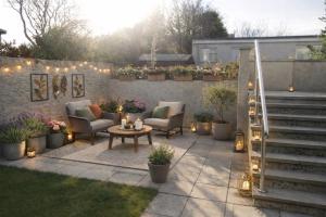 a patio with chairs and a table and lights at Crayford's Guest House in Aberdeen