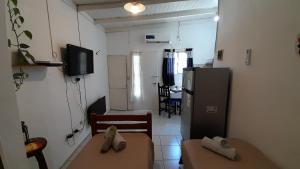 a small kitchen with a table and a refrigerator at Hostel en Almirante Brown in Villa Martín Arín