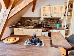 a kitchen with a wooden table and a counter top at Badischhaus am Waldrand & Weitblick in Herrischried +38 photos