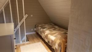 a small room with a bed in a attic at Lohusalu Apartment in Lohusalu