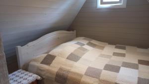 a small bedroom with a bed in a attic at Lohusalu Apartment in Lohusalu
