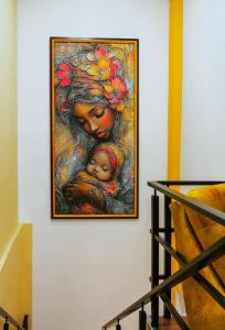a painting of a woman with a baby on a wall at Hotel Casa Santiago in Pasto