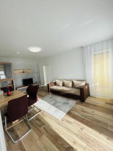 a living room with a couch and a table at Modern 2-Room Apartment with Free Parking and Balcony in Waldmohr