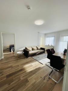 a living room with a couch and a table at Modern 2-Room Apartment with Free Parking and Balcony in Waldmohr