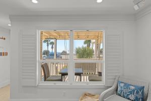 a room with a window with a table and a patio at Beach Escape, King Suite, Ocean Views, Pet Friendly in Destin