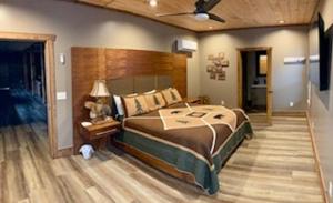 a bedroom with a large bed and a ceiling fan at Tellico River Retreat in Tellico Plains