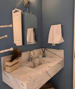 a bathroom with a marble sink and mirrors at SHB - Beach House with Air Conditioning in Santos +65 photos