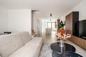 a living room with a couch and a table at Casa Blanc - Coastal Triplex in Blankenberge
