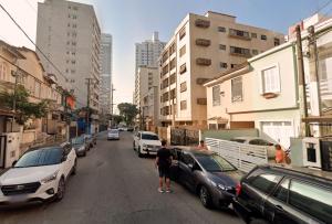 a man standing in the middle of a street with cars at SHB - Beach House with Air Conditioning in Santos