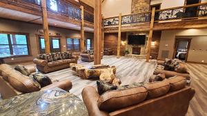 a large living room with couches and a television at Tellico River Retreat in Tellico Plains