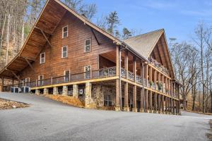 a large wooden house with a gambrel roof at Tellico River Retreat in Tellico Plains