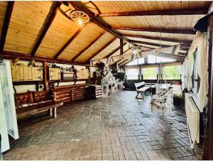 a large room with wooden ceilings and a room with tables at Cabana MARISA in Dărmăneşti