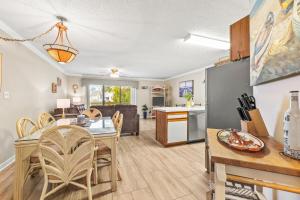 a kitchen and dining room with a table and chairs at Baytree 28G in Little River
