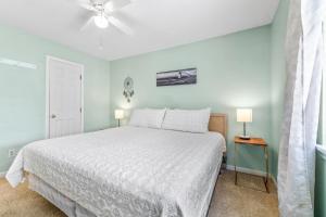 a bedroom with a bed and a ceiling fan at Baytree 28G in Little River +31 photos