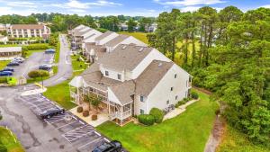 an aerial view of a large house with a parking lot at Baytree 28G in Little River