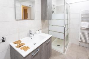 a white bathroom with a sink and a shower at Casa Cesari in Ponte Ronca +4 photos