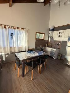 a kitchen with a table and a dining room at Betsaida2 in Lago Meliquina