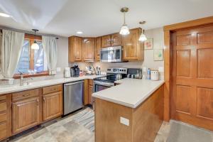 a kitchen with wooden cabinets and a counter top at Walk to Memorial Park: Pet-Friendly Bethlehem Home in Bethlehem