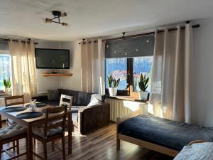 a living room with a couch and a table at Kwatery u Marysi in Szczyrk +22 photos