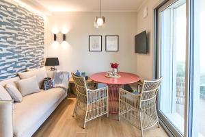 a living room with a couch and a table at À la plage B in San Benedetto del Tronto