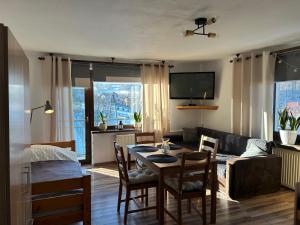 a living room with a table and a couch at Kwatery u Marysi in Szczyrk