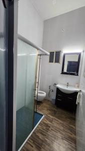 a bathroom with a shower and a sink and a toilet at The Travelers Nest Home Stay in Jhānsi +13 photos