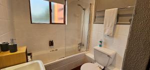 a bathroom with a toilet and a sink and a shower at Acacia at Greenway Woods in White River +6 photos