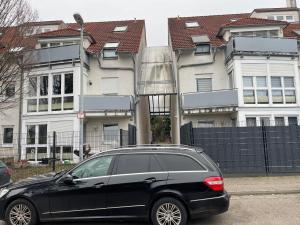 a black car parked in front of some buildings at Fewo Herrmann in Bruchsal