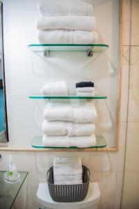 a stack of towels on a shelf in a bathroom at Beach Escape, King Suite, Ocean Views, Pet Friendly in Destin +69 photos