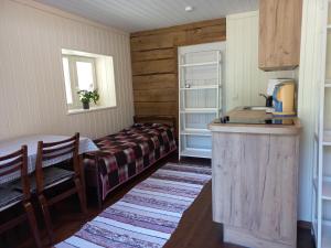a kitchen with a couch and a table in a room at Lohusalu Studio in Lohusalu