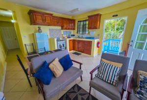 a living room with a couch and a kitchen at SK S Haven #1 in Castries