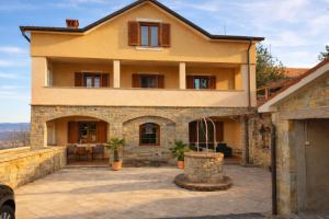 an exterior view of a house with a patio at Villa Bella Vista - For up to 6 people Villa with Sea & Castle view in Črni Kal