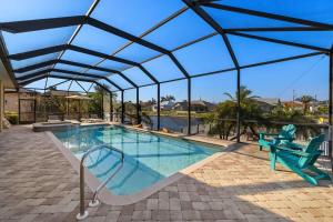 a swimming pool with a retractable roof at Villa Somada in Cape Coral