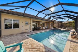 a swimming pool with a retractable roof at Villa Somada in Cape Coral