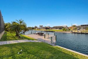 a couple sitting at a table next to a body of water at Villa Somada in Cape Coral +32 photos