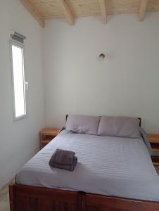 a bedroom with a bed with a towel on it at Tacuarita in Los Hornillos +34 photos