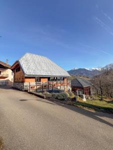 a large wooden house on the side of a road at La belle grange in Mercury