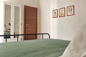 a bedroom with a bed and a wooden door at SUVAJ Rooms in Galatro