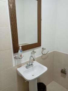 a bathroom with a sink and a mirror at Mi Casa Elena in Morelia +8 photos