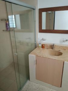 a bathroom with a sink and a glass shower at Mi Casa Elena in Morelia