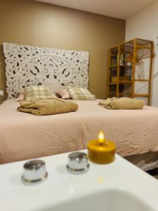 a bathroom with two beds and a sink with a candle at Gîte le Nid Dhugava in Hem-Hardinval