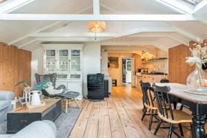 a kitchen and living room with a table and chairs at farmhouse in Wijdewormer