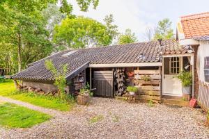 a house with a garage next to a yard at farmhouse in Wijdewormer