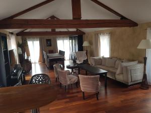 a living room with a couch and tables and chairs at Duplex T4 Sempre Endavant in Vernet-les-Bains