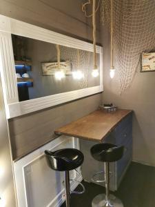 a small bar with two stools in a room at sweet home in Biella +31 photos