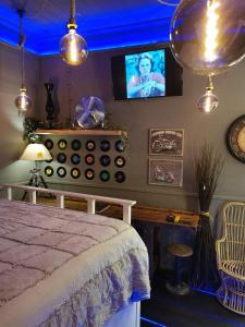 a bedroom with a bed and a tv on the wall at sweet home in Biella