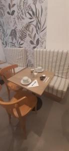 a living room with a wooden table and a couch at Cala Hotel MDP in Mar del Plata