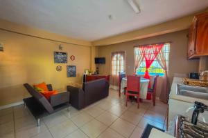 a kitchen and living room with a table and chairs at Sk SHaven #2 in Castries +5 photos