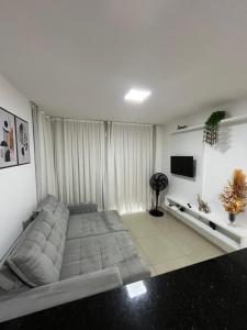 a bedroom with a large bed and a television at Seller Residence Centro in Sobral